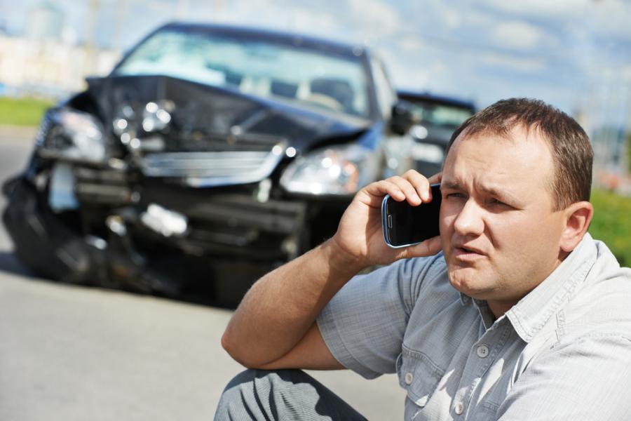 Auto Accident Lawyer Philadelphia pa car Image of car accident damage and man on cell phone HGSKlawyers.com