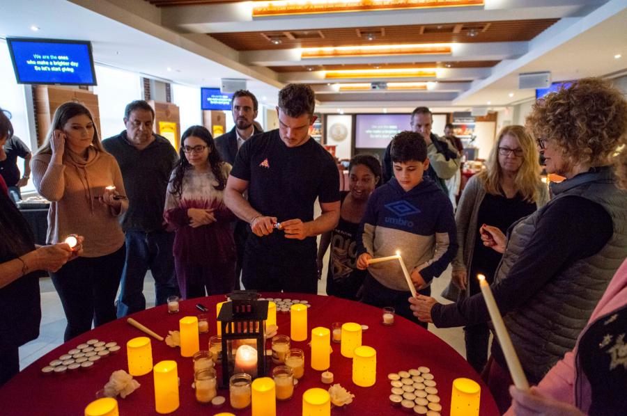 In the Church of Scientology of Tampa’s chapel, attendees of last year’s Holocaust Remembrance Day light candles before a moment of silence.