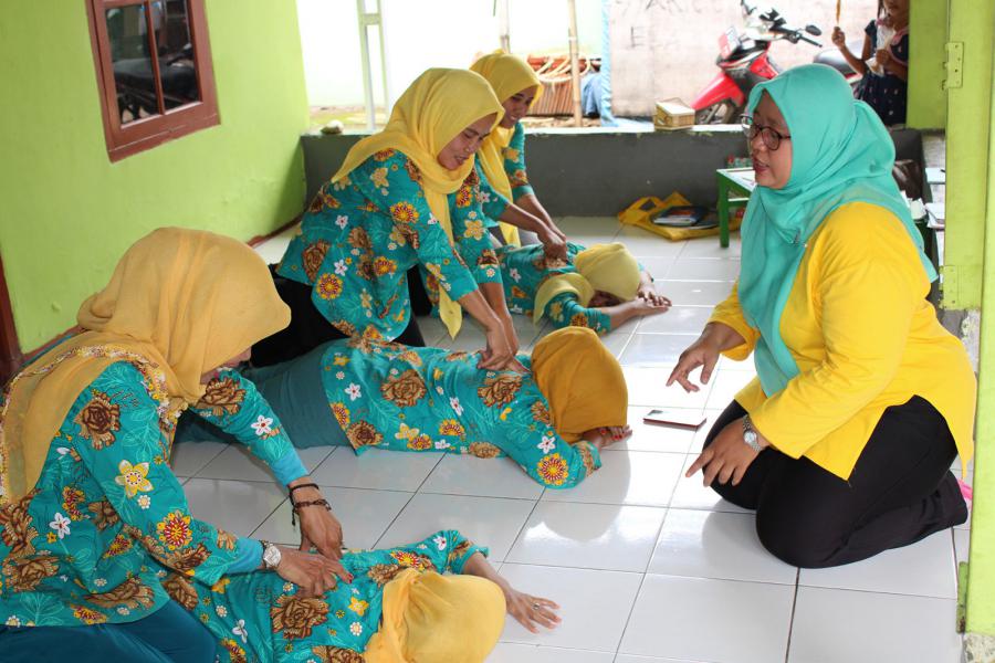 Volunteers of a local posyandu in a suburb of Jakarta practice administering assists.