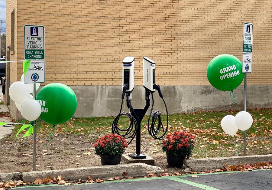SemaConnect Series 6 smart networked EV charging stations on dual pedestal with green Grand Opening balloons at Pend Oreille PUD's Newport Administration Building