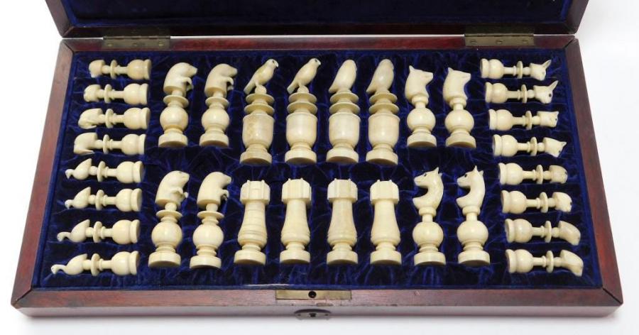 Immaculate, hand-carved Alaskan Inuit walrus ivory chess set, the pieces modeled after native fauna with exquisite calcification. Estimate: 3,000-$5,000.