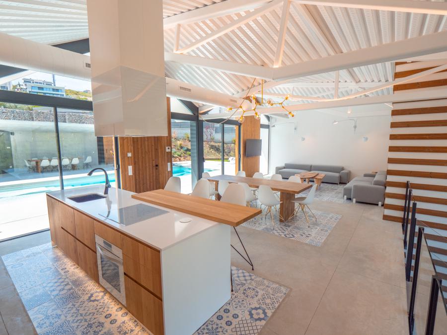 The island kitchen and lap pool of a luxury Spanish villa.