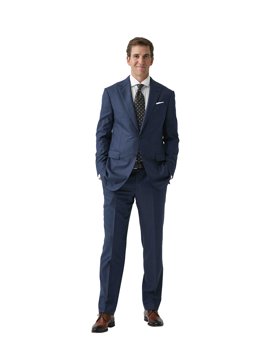 Photo of former NFL QB Eli Manning wearing a business suit
