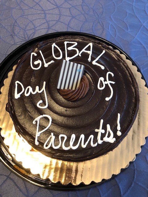 Chocolate cake w/ 'Global Day of Parents' in white icing