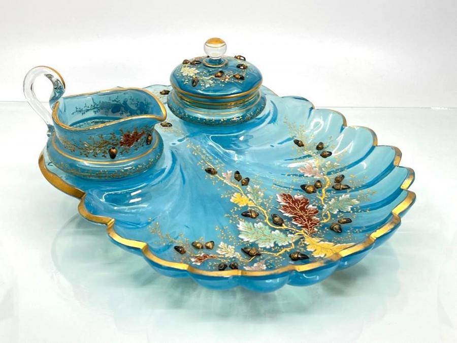 Moser enameled glass strawberry stand in pale blue translucent glass molded in the form of a scallop shell, fitted with a cream jug and covered sugar dish, 11 inches tall (est. $800-$1,200).