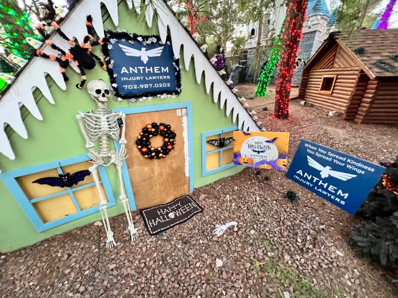 A house decorated with spooky skeletons, bats, and spiders is the Anthem Injury Lawyers Display at HallOVeen at the Magical Forest