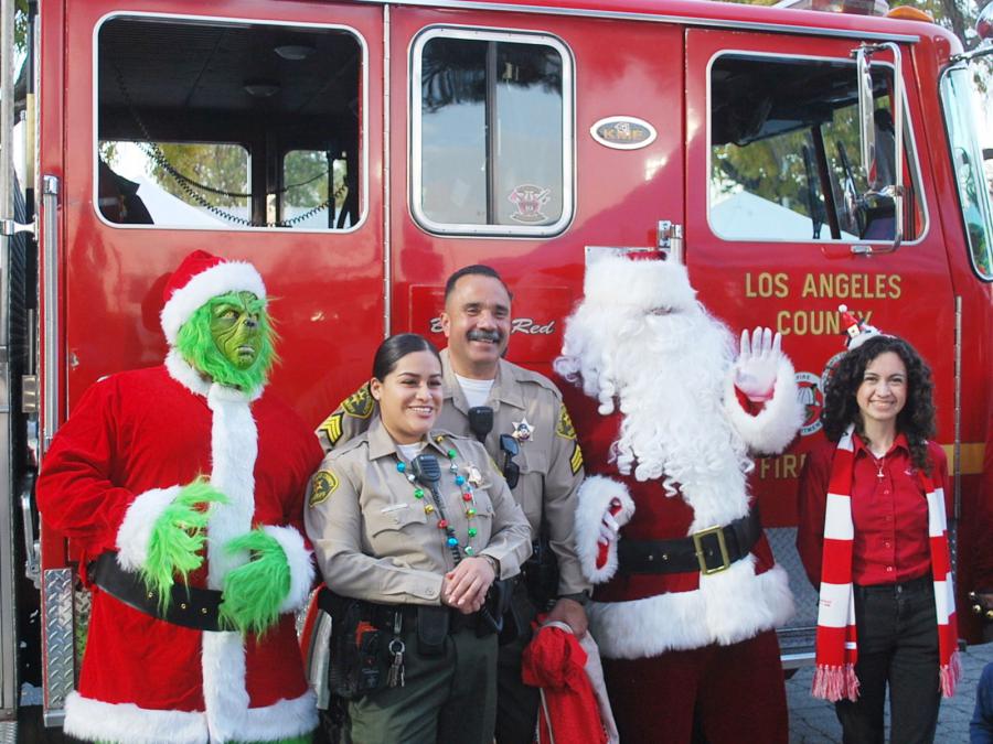 The Grinch and Santa joined the East L.A. Sheriff’s Department and Bridge Publications Director of Public Relations at the toy giveaway at the East L.A. Winter Wonderland December 3 at Bellevedier Park.