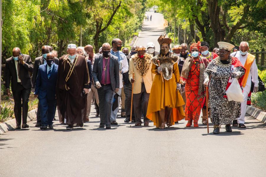 Religious leaders from all faiths walking peacefully to demonstrate religious unity.