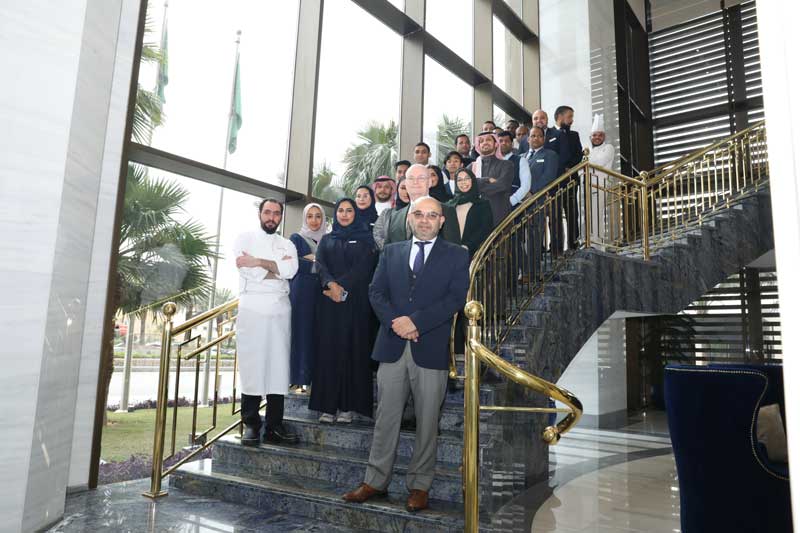 Movenpick Hotel and Residences Riyadh staff photo on grand staircase