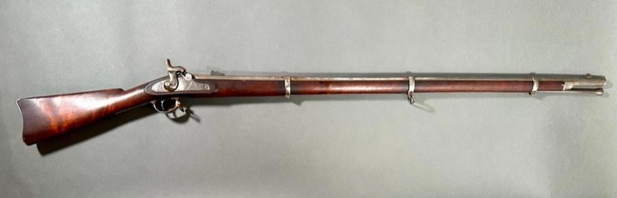 1863 Colt Civil War contract rifle musket with an engraved side plate, percussion strike, steel ramrod and walnut stock with burl, stamped throughout, 55 ½ inches long (est. $2,000-$3,000).