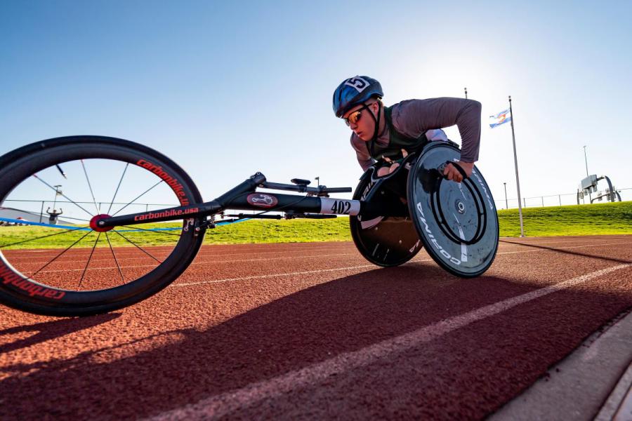 Athlete in a racing wheelchair on the track