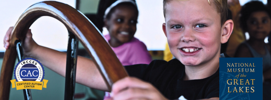 Young boy at the helm of the ship at the National Museum of the Great Lakes