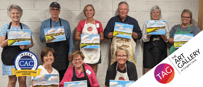 TAG visitors pose with their finished paintings after a painting workshop at the gallery.