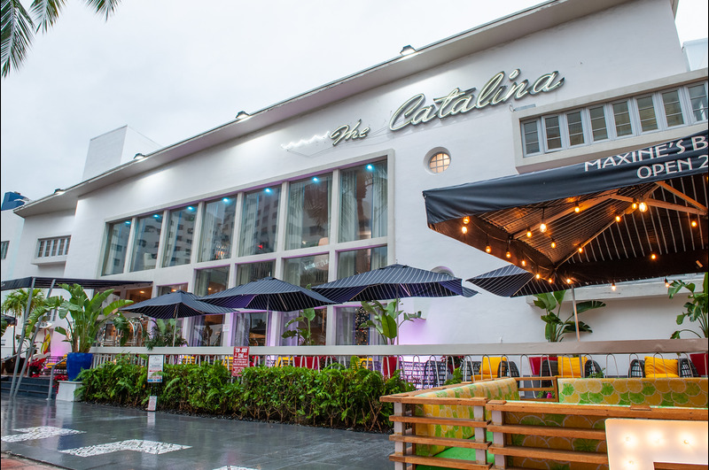 HotelsByDay, the premier day use hotel booking platform, is excited to announce a partnership with the stylish Catalina Hotel & Beach Club in the heart of Miami Beach Entrance of Catalina Hotel with palms trees and outside dining area.