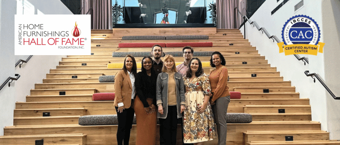 American Home Furnishing Hall of Fame Foundation team standing on staircase