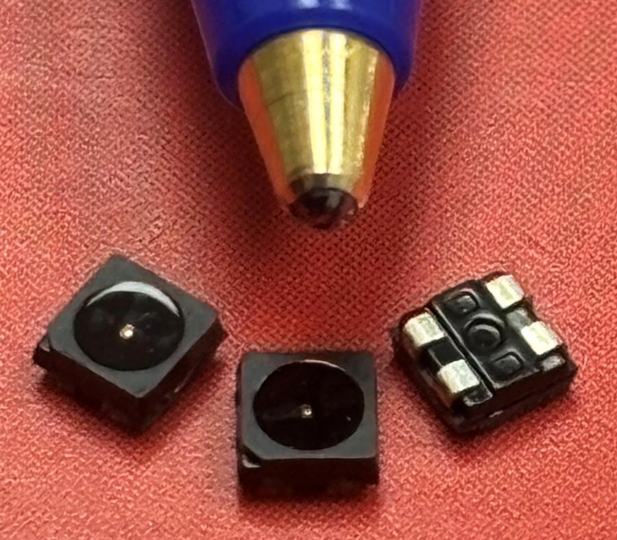 Image of red dot LEDs next to ball point pen for size comparison