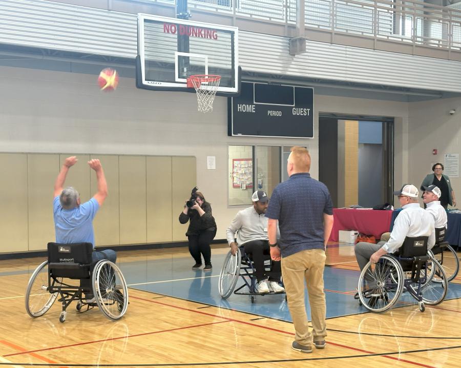 individuals playing basketball in a gym