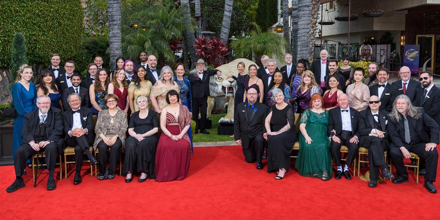 The Writer and Illustrator Winners and Judges next to a 5 foot tall saber tooth tiger at the Taglyan Complex in Hollywood for the 40th Annual Gala.