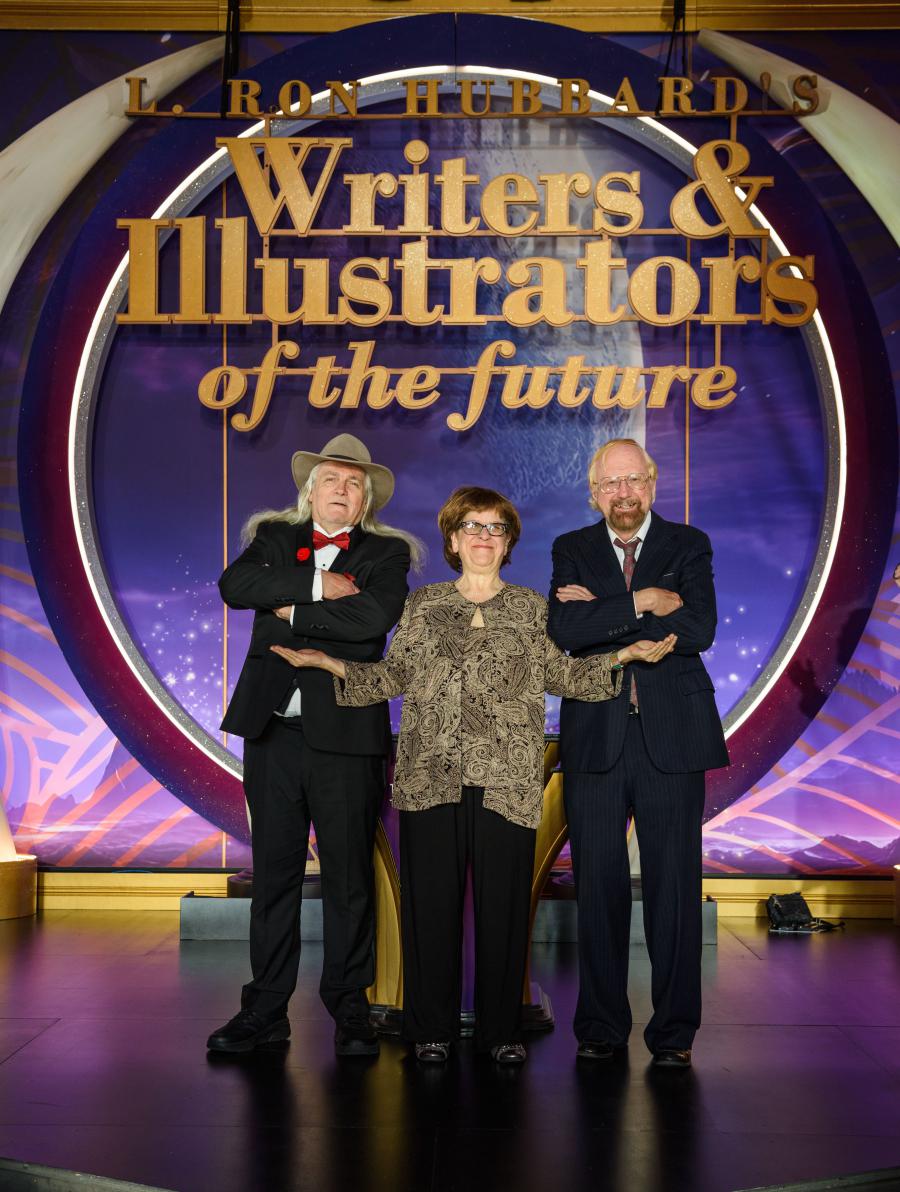 [l to r] Dean Wesley Smith, Nina Kiriki Hoffman, and Leonard Carpenter, Volume 1 alumni, on the stage attending the Writers of the Future Volume 40 Gala.