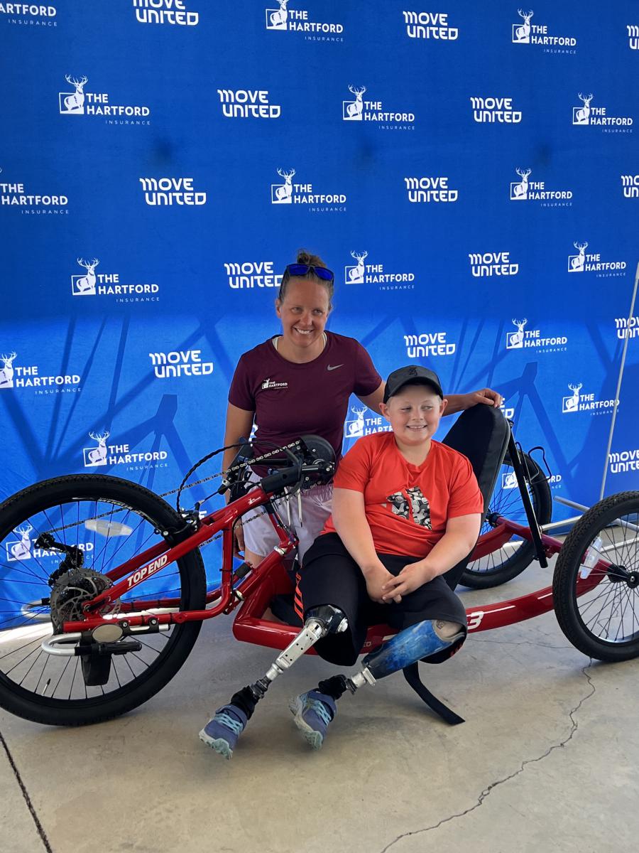 Hailey and Luke pose with new adaptive sports equipment