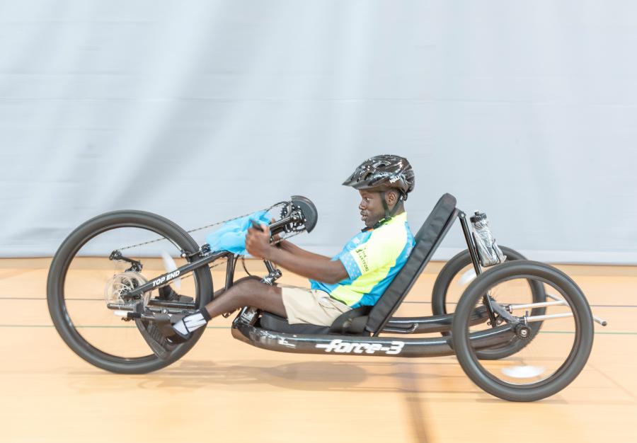 15-year-old John Pittman tries out the handcycle he was just surprised with