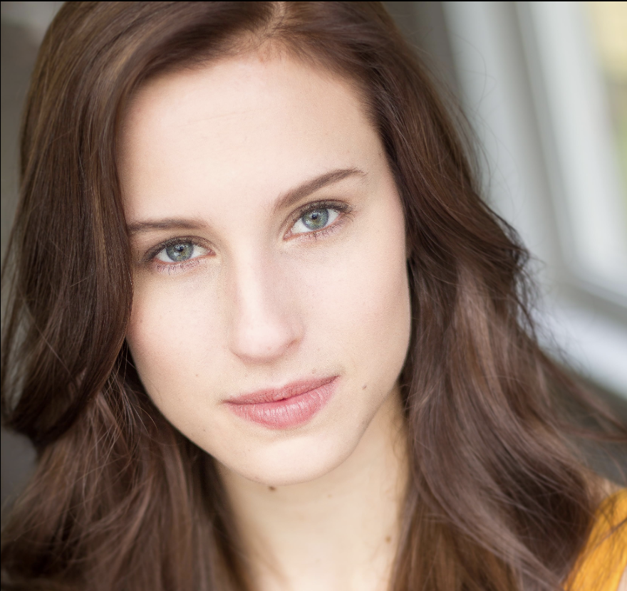 Headshot of Mary Risener, Industry Network alum, featuring her in a yellow top with soft brown hair and striking green eyes, exemplifying the talent developed at The Industry Network.