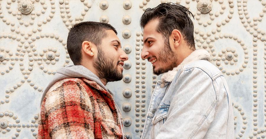 Two young Arab gay men standing close together, representing the resilience of the LGBTQ+ community in the Arab world.