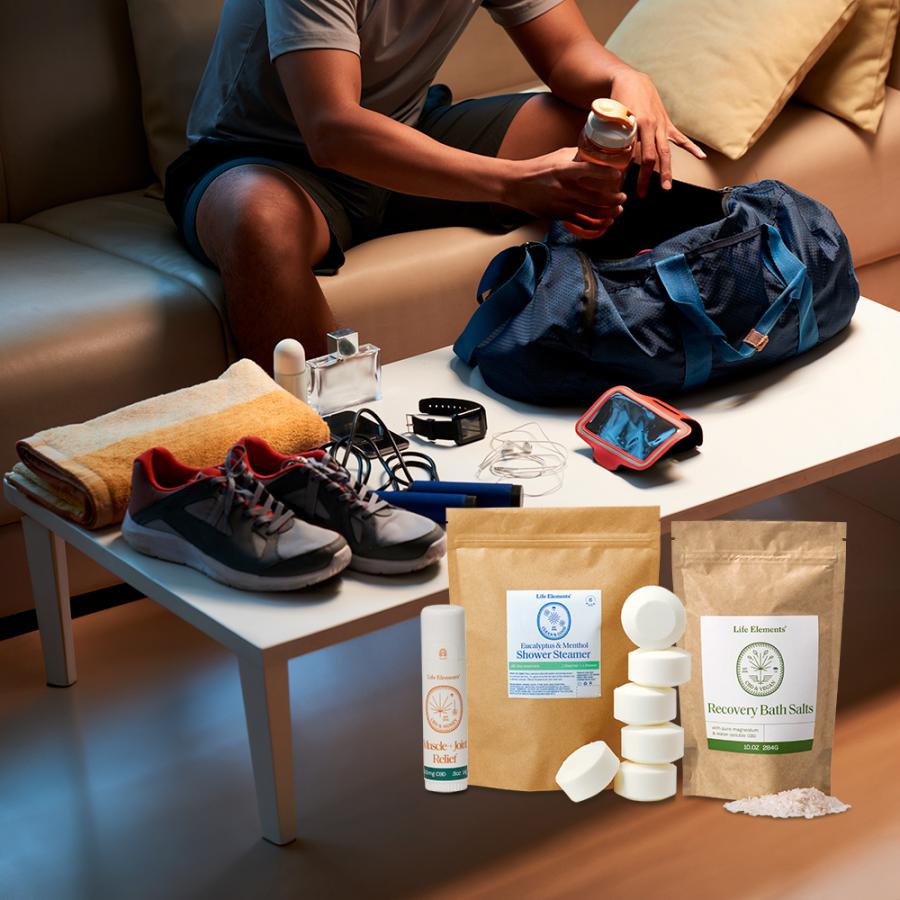 Photo of a Man Packing his Sporting Gear featuring Life Elements Sports Gift Set Bundle to include Muscle & Ache Relief Stick, Recovery Bath Salts, and Shower Steamers