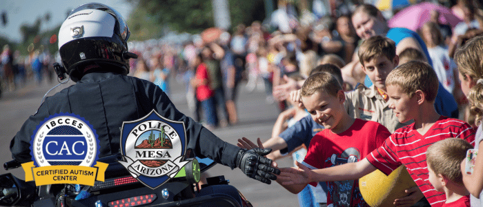 A police officer warmly greeting children during a parade, fostering a sense of community and trust.