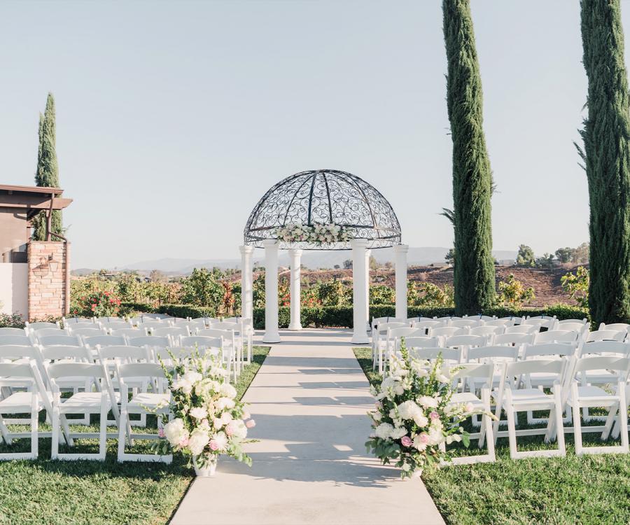 Beautiful garden ceremony site with domed structure and cypress trees with surrounding vineyards