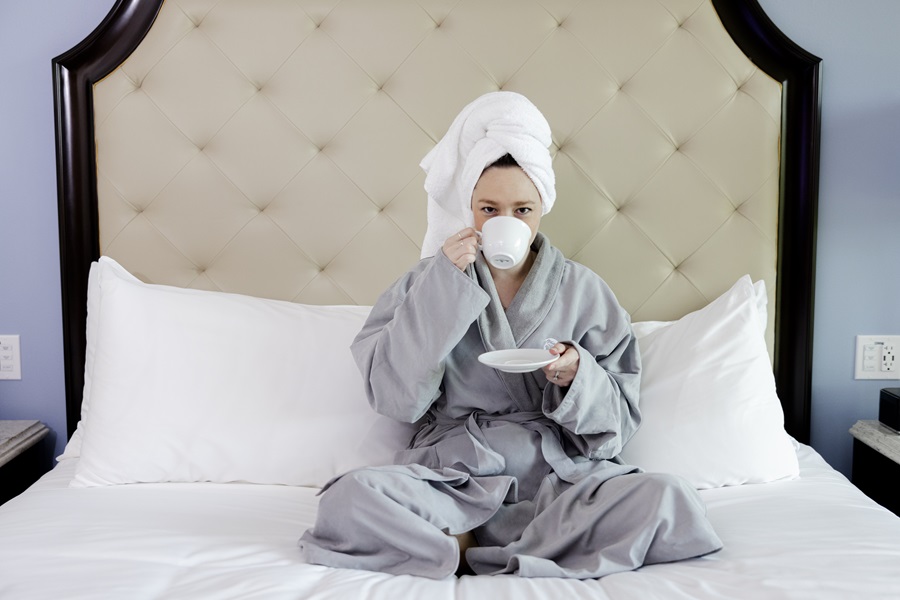 woman in turban towel on hotel bed