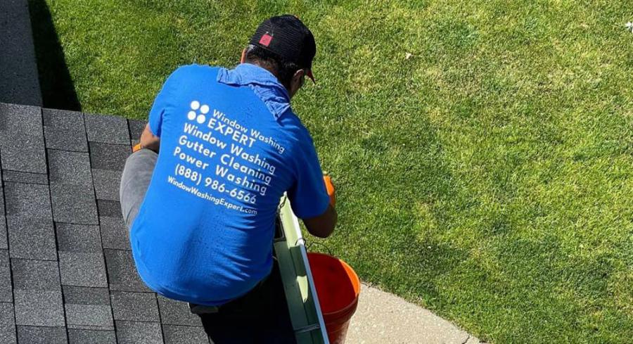 man cleaning gutters