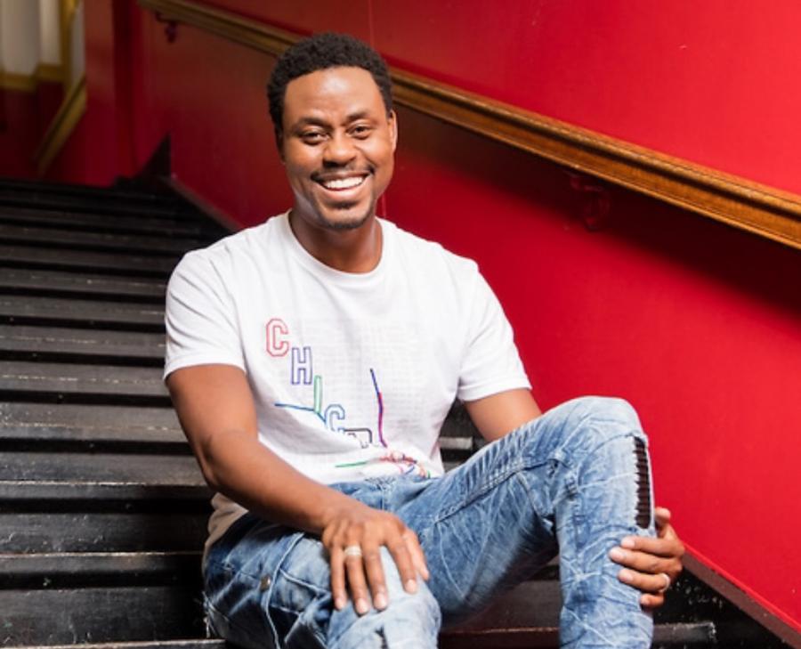 Charles Jenkins sitting on the stairs at a school.