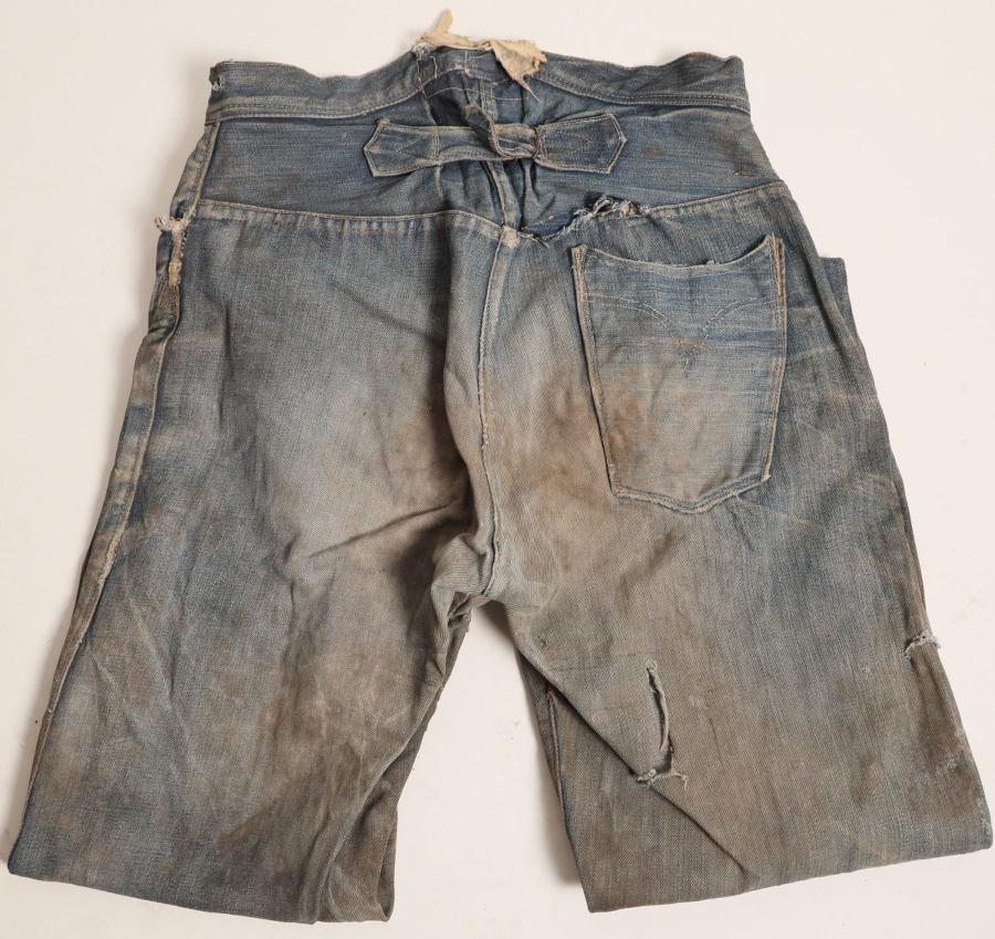 Pair of button fly Mountaineer brand jeans from ZCMI of Salt Lake City. Discovered in a house in Utah as insulation lining the walls in 2024, the pants boasted a Mormon connection ($21,250).