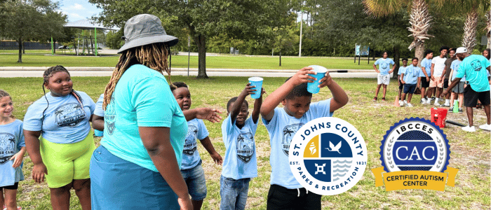 Children and a staff member participate in an outdoor activity at St. Johns County Parks and Recreation, with the St. Johns County and IBCCES Certified Autism Center™ logos displayed.