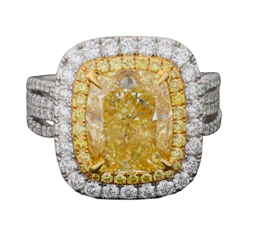 Lady’s 18k two-tone gold canary diamond dinner ring with a cushion cut 5.03-carat natural yellow diamond with conforming borders of tiny round brilliant cut diamonds (est. $50,000-$80,000).