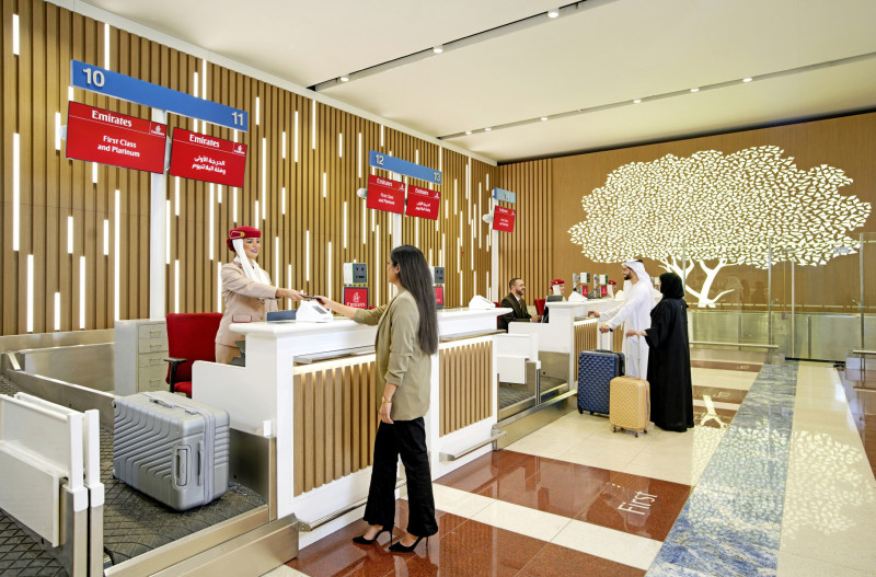 A woman checking in at the Emirates Check in Counter at DXB Terminal 3