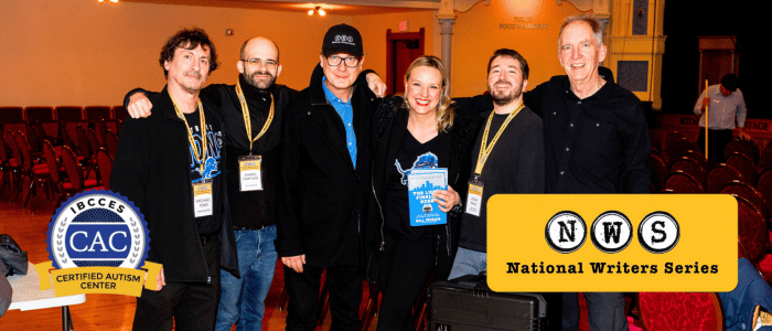 Group of people in a conference hall smiling for the photo, with a "National Writers Series" logo and CAC badge on the graphics.