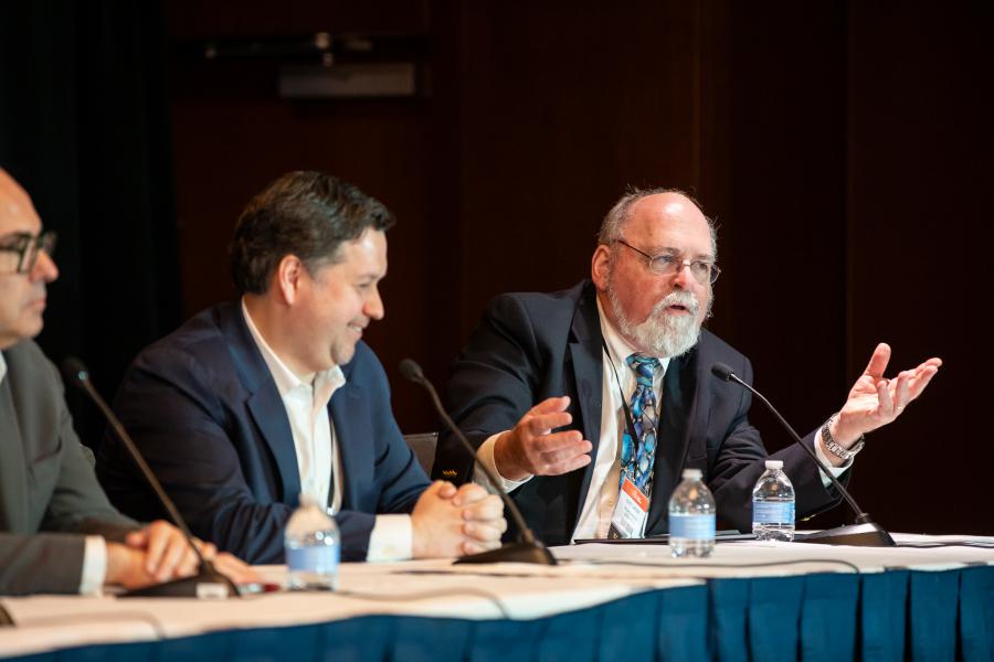 Three people participating in a panel discussion