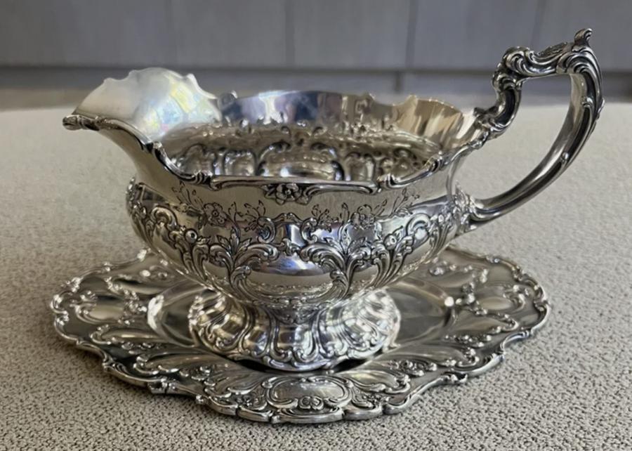 Gorham sterling silver Chantilly boat with under plate, weighing a total 19 troy ounces and the tray measuring about 8 ½ inches by 6 ½ inches (est. $1,900-$2,600).