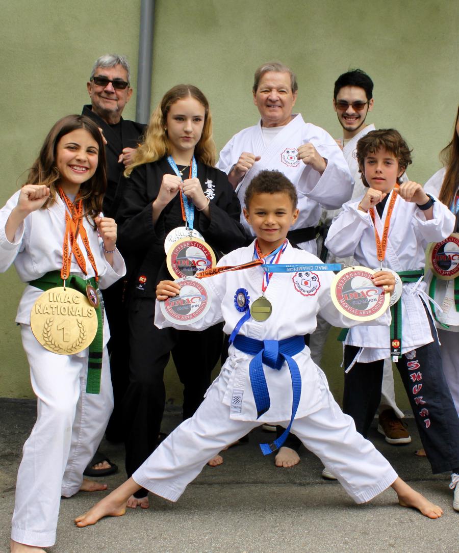 Gerry Blanck (center right) with his award-winning students before LA fires destroyed their Pacific Palisades dojo. A May 17 gala at Hilton Santa Monica will raise funds to rebuild and support youth martial arts. Photo credit: Diamond Media.