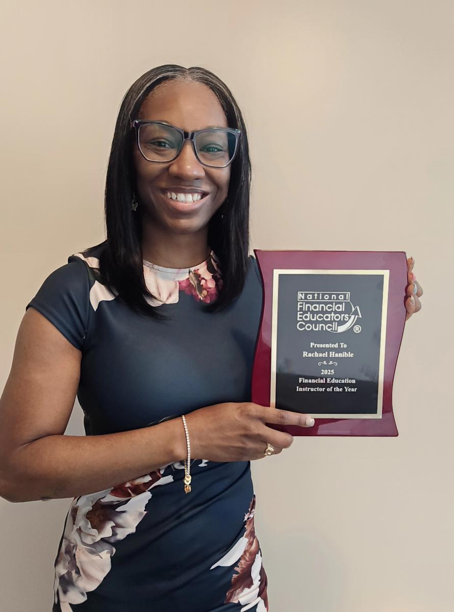 Rachael Hanible holding the Financial Education Instructor of the Year award