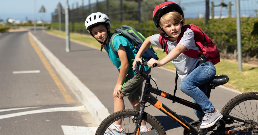 Image of the two boys riding bike to school