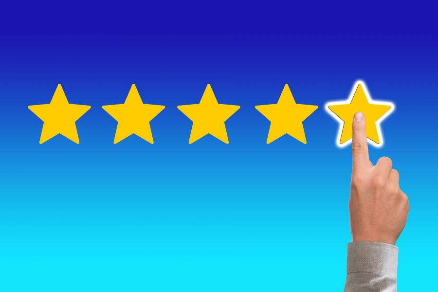 Touchscreen display with five star review being selected