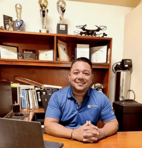 CEO Martin Lopez seated at his office desk, smiling at the camera