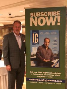 Doug Laney father of Infonomics stands next to his banner at the information governance and infonomics summit in new york city