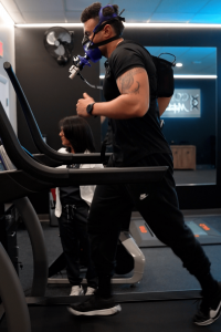 Physical trainer completing VO₂ Max testing using the PNOĒ system on a treadmill at MetaLab inside Confidia Health Institute in Bristol, Connecticut.