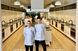 Photo of Iron Chef Cat Cora & LKA Founder, Felicity Curin standing in Little Kitchen Academy together in chef coats