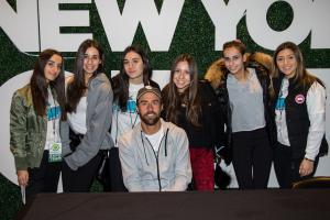 American tennis professional Steve Johnson takes a picture with guests at the 2019 New York Tennis Expo.
