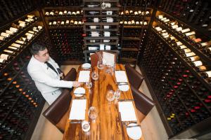 There is nothing more romantic than dining under a waterfall of wine bottles in TRIBUTE’s exclusive wine room.